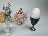 several figurines of people and an egg on a table