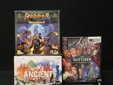 three video games sitting on a table with a black background