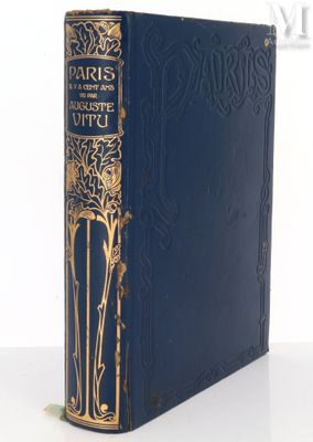 a blue book sitting on top of a table next to a white wall