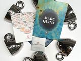 a bunch of coffee cups and a book sitting on a table