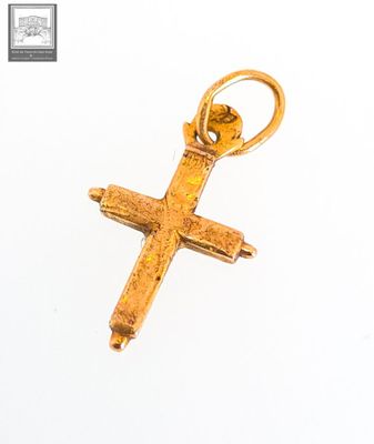 an image of a gold cross pendant on a white background