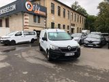 a white van parked in front of a building with cars parked in front of it