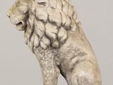 a statue of a lion that is sitting on a table