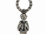 a silver knife with a statue of a man holding a knife
