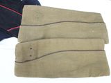 three pairs of pants are lined up on a white surface