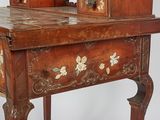 a small wooden table with a mirror on top of it