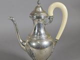 an antique silver tea pot with a handle and handle