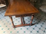 a wooden table with two drawers on it in a room