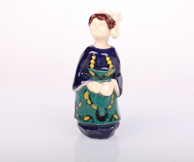a ceramic figurine of a woman holding a cat