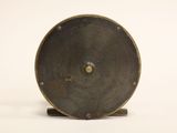 a metal object that is sitting on a white surface