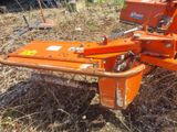 an orange plow that is sitting in the grass