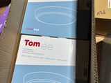 two boxes of tom products sitting on a table