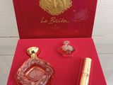 a red box with a perfume bottle and a lipstick in it