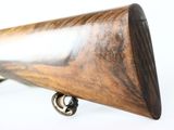 a close up of a rifle with a wooden barrel on a white background