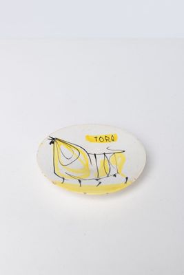 a white plate with a drawing of a banana on it