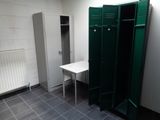 two green lockers and a white table in a room