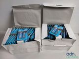 two boxes of toothpaste and toothbrushes sitting on a table
