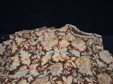 a brown and blue floral print shirt on a black background