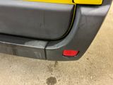a yellow sticker on the back of a yellow car