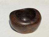 a small wooden bowl on a white surface