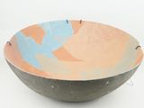 a bowl with a design on it on a white surface