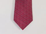a close up of a red tie hanging on a wall