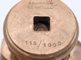 a close up of a metal object on a white surface