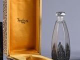 a small glass bottle and a glass salt shaker in a box