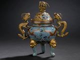 a blue and gold vase with a dragon on it