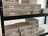 many boxes that are on the shelves in the room