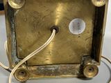 a gold clock that is sitting on a table
