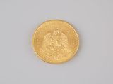 an image of a close up of a gold coin on a white surface