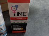 a bottle of time and a box on a table