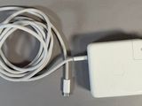 an apple power adapter plugged into a charger on a table