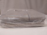a stack of towels wrapped in plastic on a table