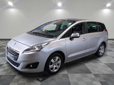 a picture of a silver minivan parked in a garage