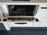 a dishwasher that is open in a kitchen