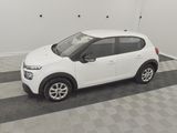 a picture of a small white car parked in a garage
