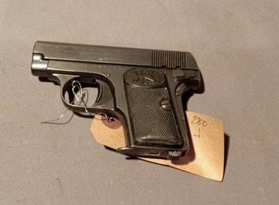 a gun that is laying on a piece of paper