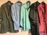 four coats hanging on a wall next to each other