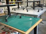 a table with a green mat on it in the middle of a room