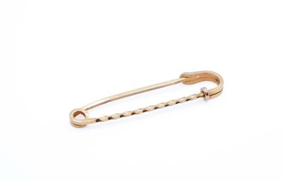 a close up of a gold safety pin on a white background