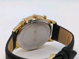 a close up of a watch on a white surface