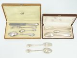 a box with silverware in it on a white surface