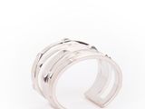a close up of a silver ring on a white background
