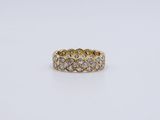 a yellow gold ring with diamonds on a white background