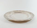 an antique silver plate on a white table with a white background