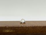pair of diamond stud earrings sitting on top of a wooden box