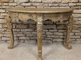 an antique console table with a gold finish and ornate carvings