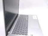 a silver laptop computer sitting on a white surface